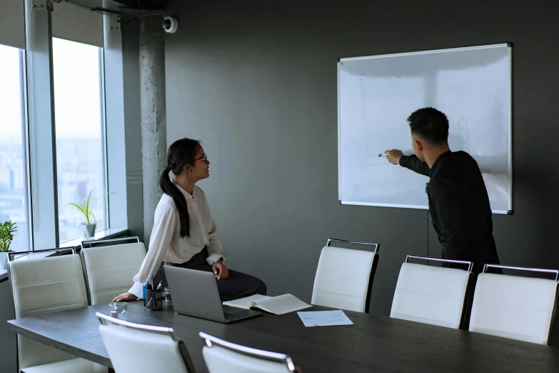 a man and a woman standing in front of a whiteboard, pexels contest winner, cubical meeting room office, background image, te pae, darren quach