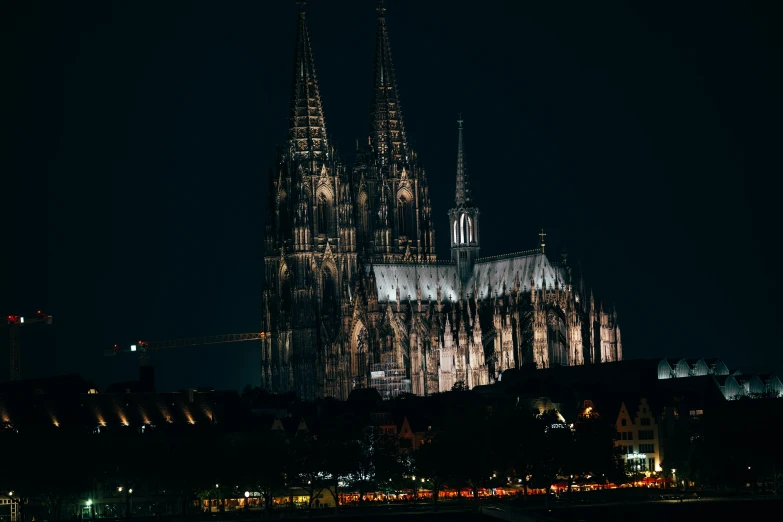 a large cathedral lit up at night next to a body of water, by Tobias Stimmer, pexels contest winner, international gothic, 2 5 6 x 2 5 6, plain background, german renaissance architecture, festival. scenic view at night