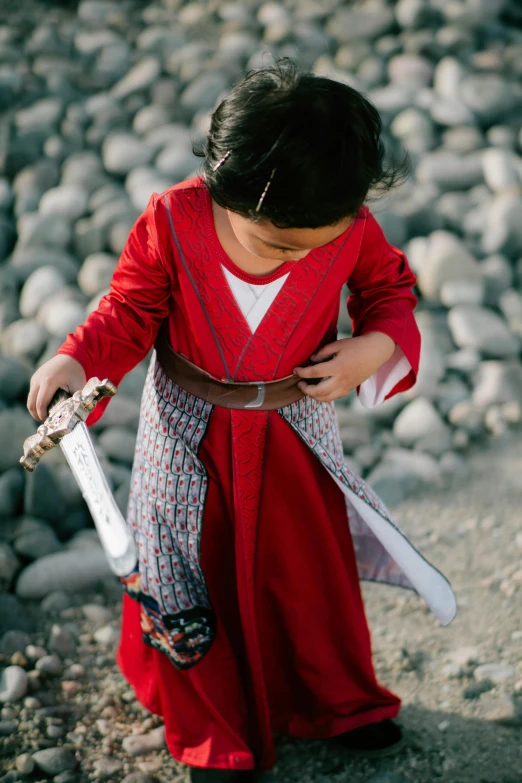 a little girl in a red dress holding a sword, inspired by Kanō Hōgai, unsplash, wearing jedi robes and a sari, hero shot, moana, tunic