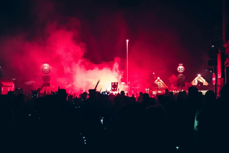 a crowd of people standing in front of a red light, pexels contest winner, graffiti, police sirens in smoke, festival. scenic view at night, gradient red to black, instagram post
