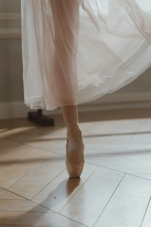 a close up of a person wearing ballet shoes, a picture, by Elizabeth Polunin, trending on unsplash, arabesque, delicate soft hazy lighting, stride, 8l, rectangle