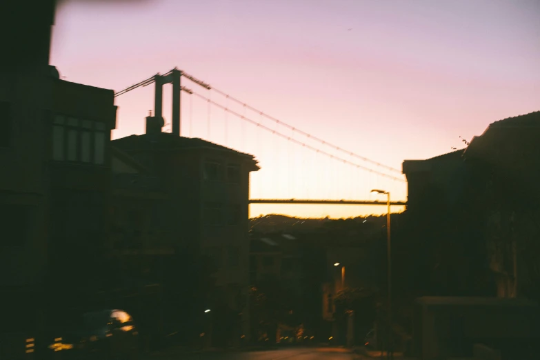 a city street at dusk with a bridge in the background, pexels contest winner, overexposed sunlight, bay area, tumblr aesthetic, multiple stories