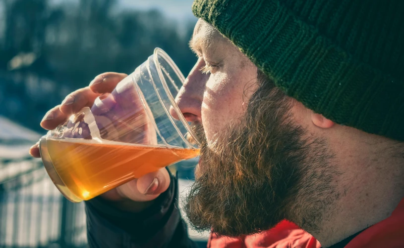 a man with a beard drinking a glass of beer, pexels contest winner, winter sun, new england ipa, avatar image, beakers