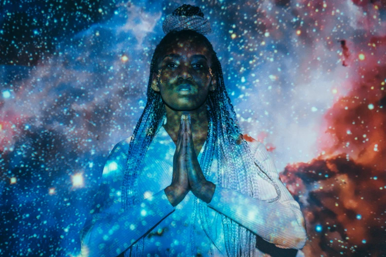a woman standing in front of a star filled sky, a hologram, afrofuturism, religious imagery, blue bioluminescence, photo of a black woman, kundalini energy