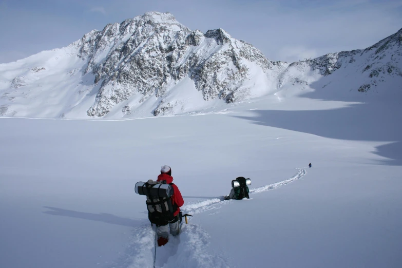 a man riding skis down a snow covered slope, carrying survival gear, grand majestic mountains, inlets, profile image