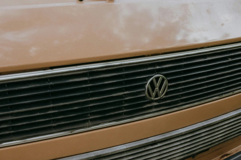 a close up of a volkswagen logo on a car, a picture, unsplash, brown, vhs, truck, restoration