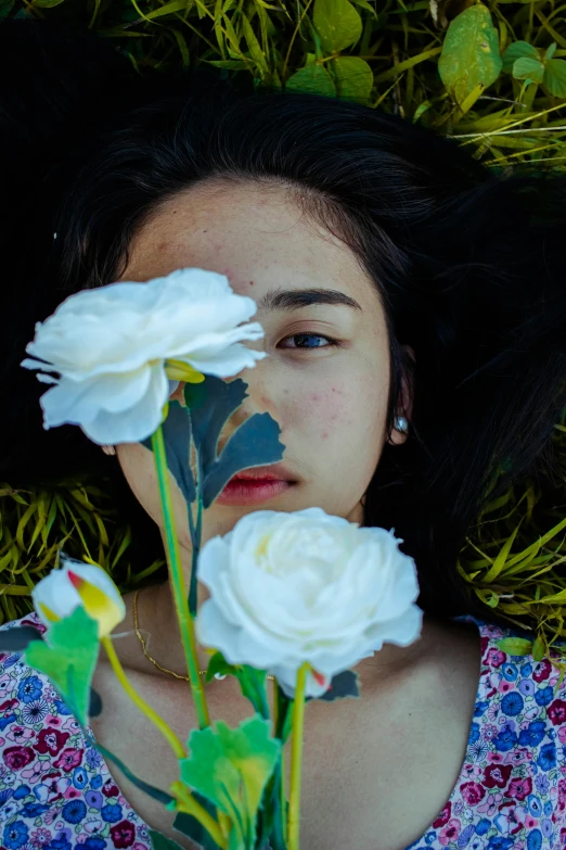 a woman laying in the grass with a bunch of flowers, an album cover, inspired by Ren Hang, unsplash, hyperrealism, headshot, vietnamese woman, teenage girl, on black background