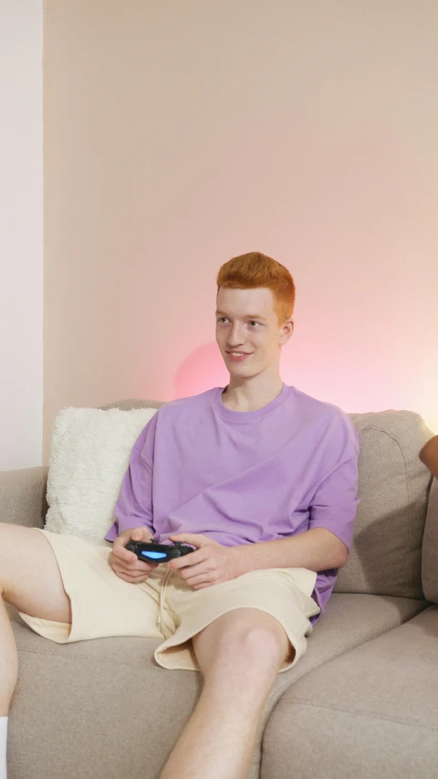 two men sitting on a couch playing a video game, ginger hair with freckles, purple hue, he has a glow coming from him, riyahd cassiem
