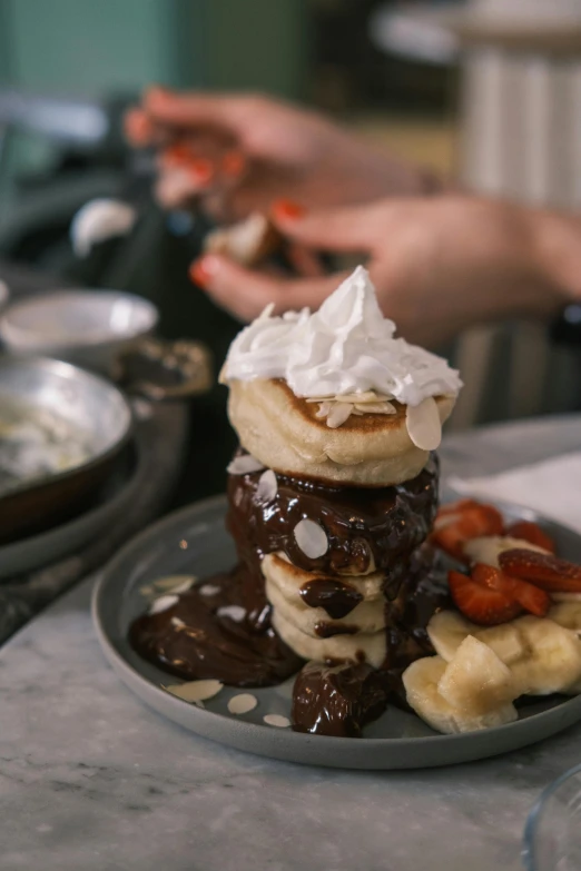 a close up of a plate of food on a table, chocolate sauce, flat pancake head, overflowing, banana