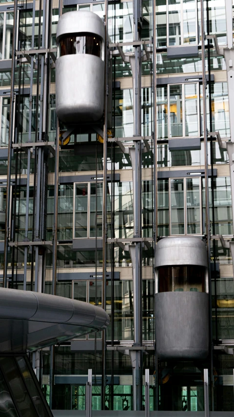 a very tall building with a lot of windows, inspired by Thomas Struth, with big chrome tubes, wet metal reflections, parliament, photographed for reuters