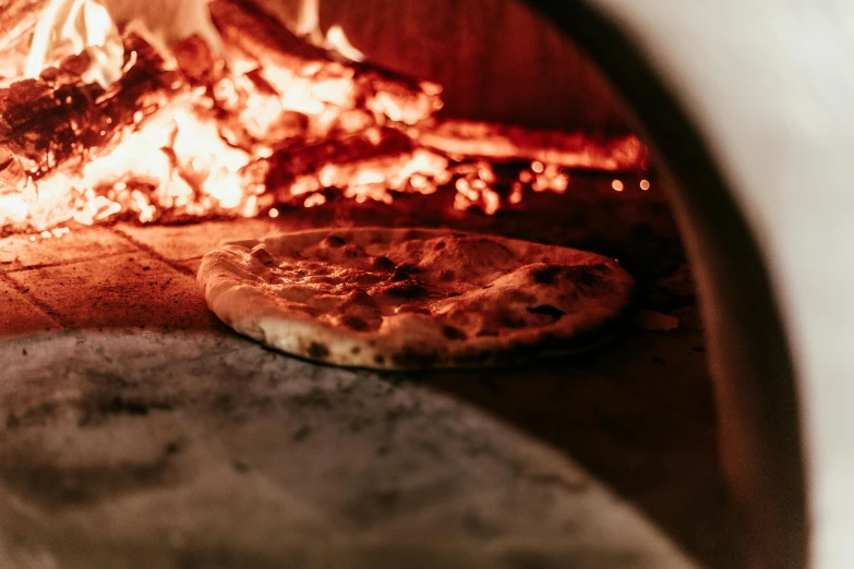 a couple of pizzas sitting on top of a pizza oven, a photo, by Lee Loughridge, trending on unsplash, made of glazed, embers to waist, covered in white flour, profile image