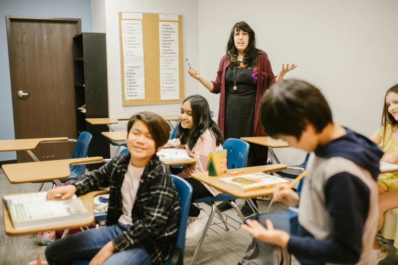 a group of children sitting at desks in a classroom, a portrait, by Meredith Dillman, pexels contest winner, vancouver school, avatar image, standing in class, andy milonakis, behind the scenes photo