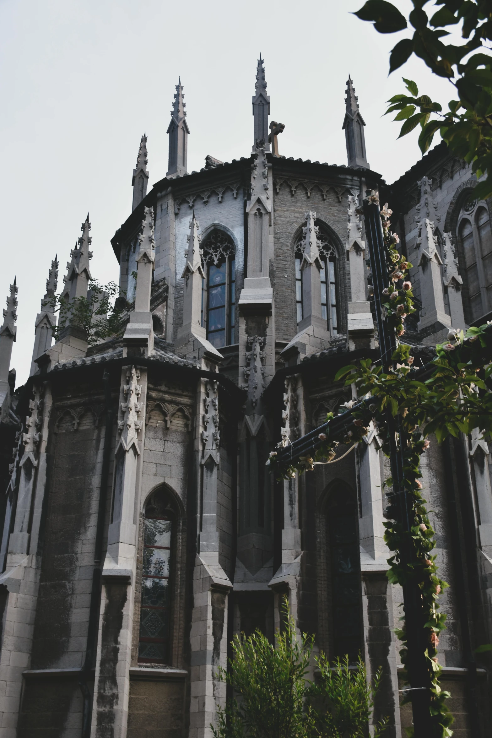 a very tall building with a clock on it's side, by Gaudi, pexels contest winner, international gothic, cemetery, zhangjiajie, grey, papa emeritus