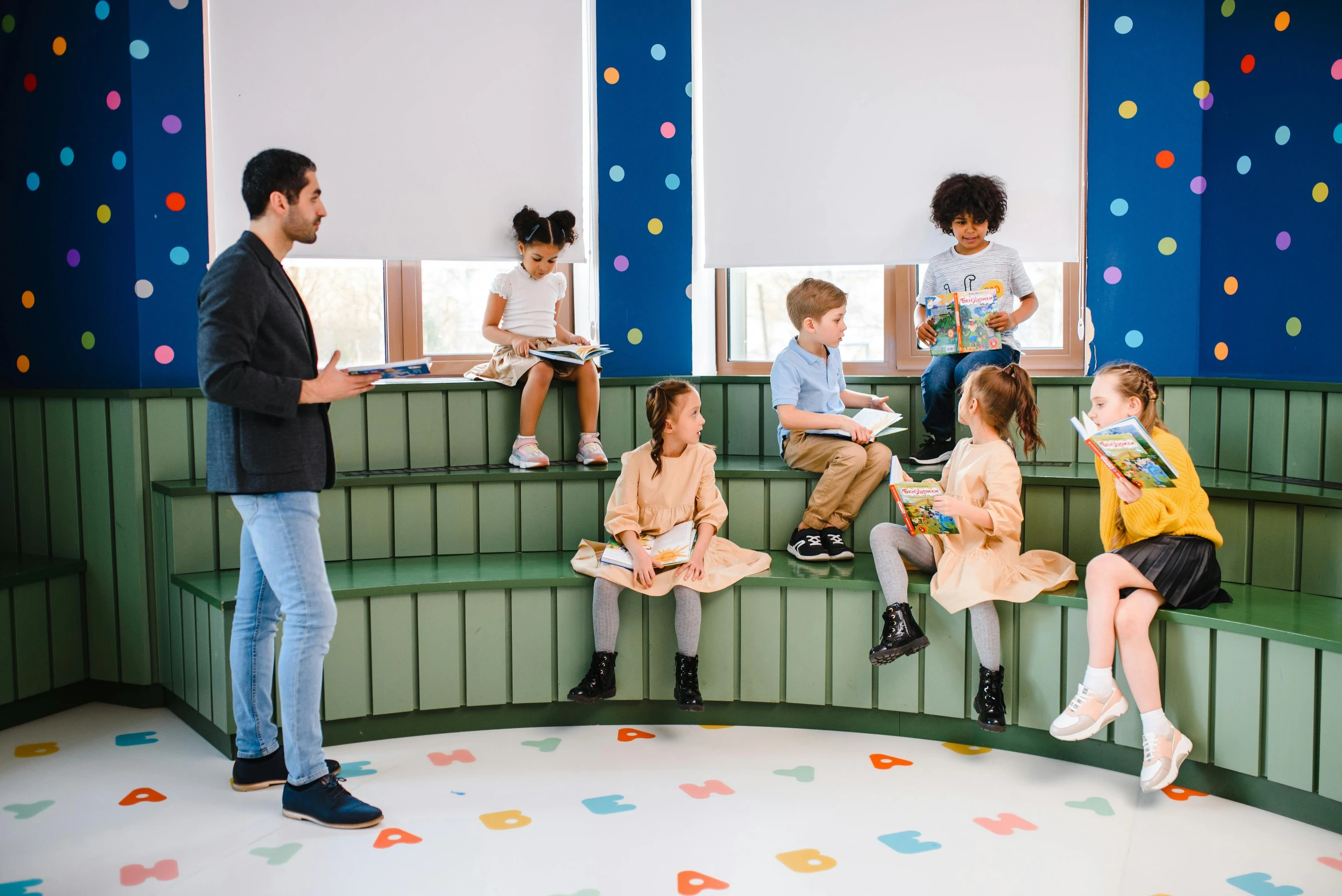 a man reading a book to a group of children, a cartoon, inspired by david rubín, pexels contest winner, danube school, conversation pit, benches, softplay, very stylish