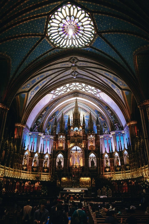 a large cathedral filled with lots of people, an album cover, by Clément Serveau, pexels contest winner, quebec, glowing blue interior components, beautiful gold saint, 2 5 6 x 2 5 6 pixels