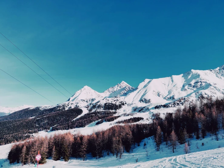 a group of people riding skis down a snow covered slope, pexels contest winner, les nabis, bright blue sky, winter landscape outside, 🦩🪐🐞👩🏻🦳, panorama view