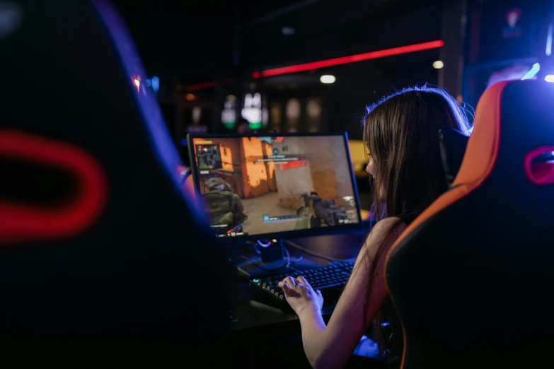 a woman playing a video game on a computer, a screenshot, pexels, server in the middle, blue and orange rim lights, instagram post, high resolution image