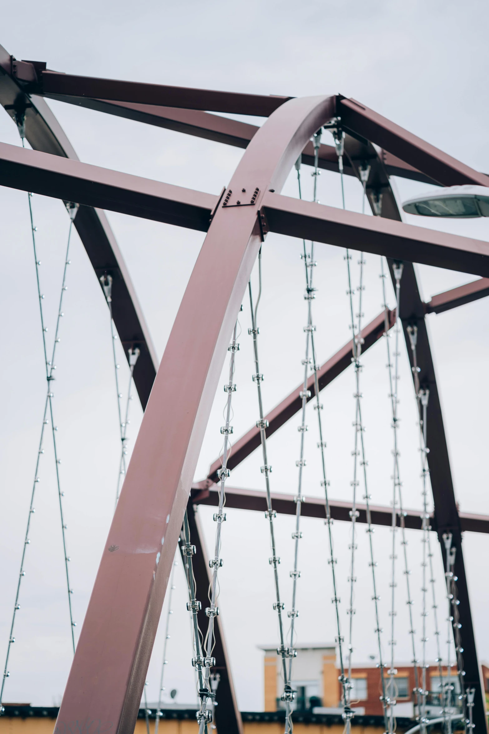 a man riding a skateboard on top of a metal bridge, an album cover, by Jacob Toorenvliet, unsplash, detail structure, ((chains)), maroon and white, albuquerque