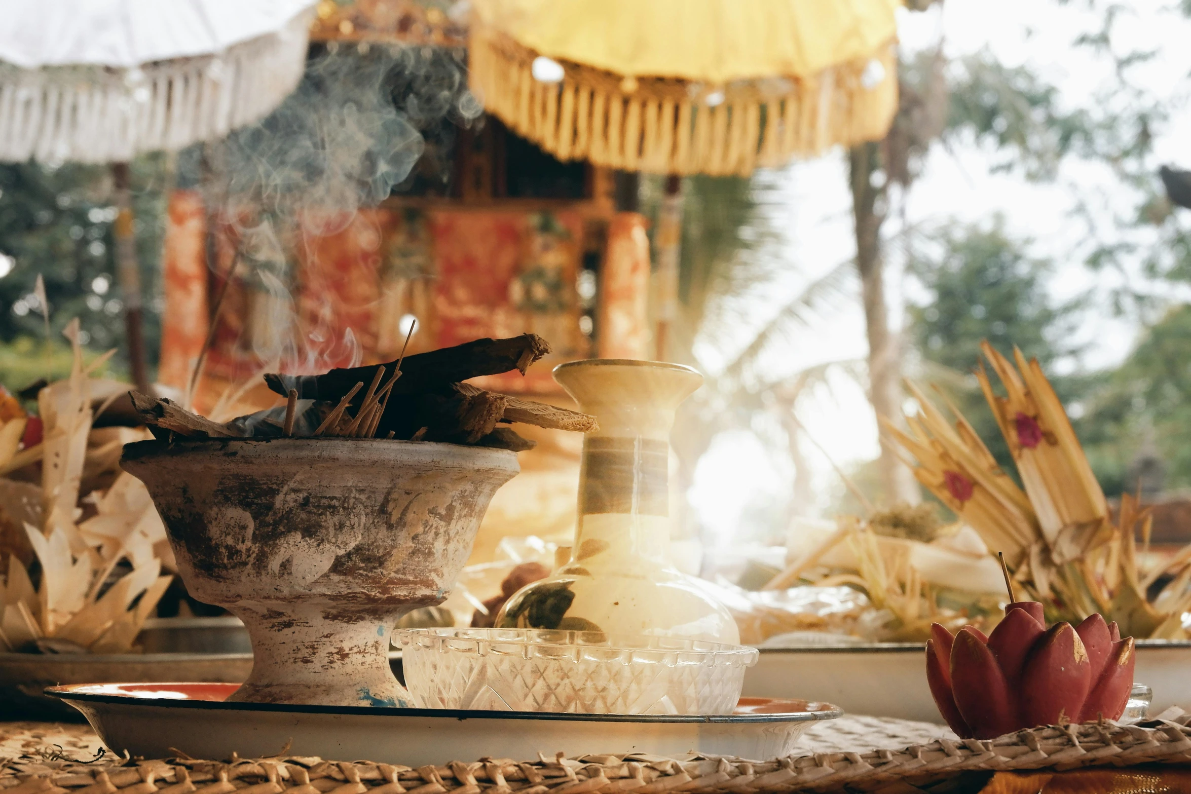 a close up of a bowl of food on a table, a still life, incense smoke fills the air, tropical atmosphere, mythical shrine, sol retreat