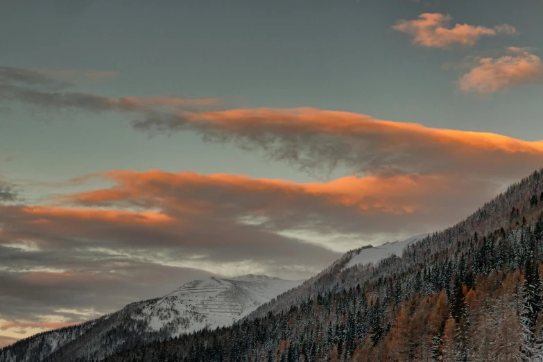 a group of people riding skis down a snow covered slope, a matte painting, by Cedric Peyravernay, pexels contest winner, romanticism, orange clouds, seen from afar, late autumn, whistler