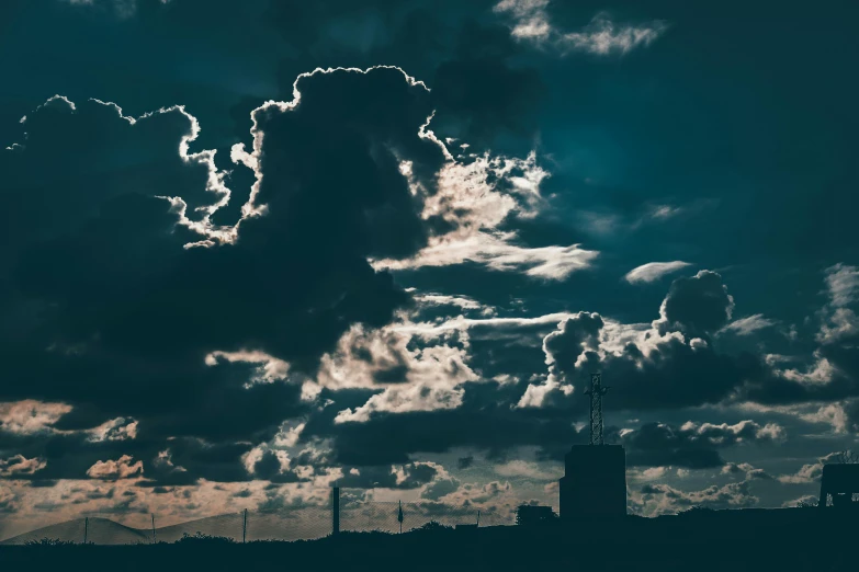 a large cloud in the sky over a city, by Adam Marczyński, unsplash contest winner, surrealism, silhouetted, industrial photography, dramatic lighting - n 9, tall fluffy clouds