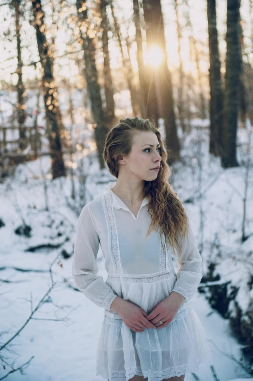 a woman in a white dress standing in the snow, inspired by Elsa Bleda, pexels contest winner, portrait of white teenage girl, britt marling style 3/4, in nature, half - length photo