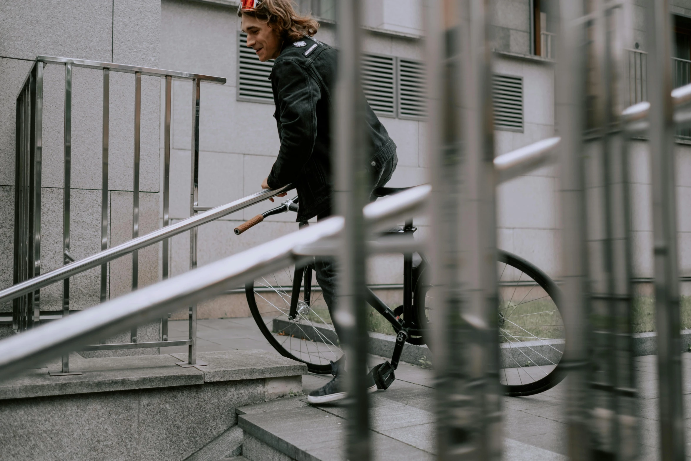 a man riding a bike down a set of stairs, pexels contest winner, wearing urban techwear, b - roll, ::