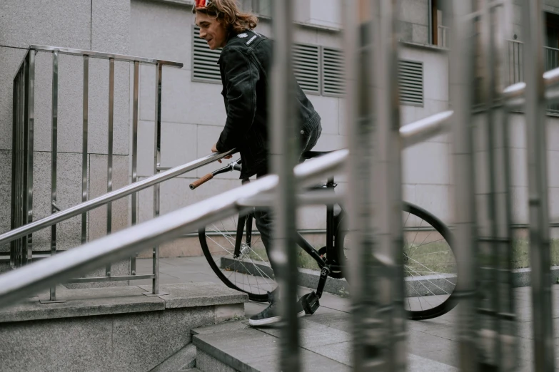 a man riding a bike down a set of stairs, pexels contest winner, wearing urban techwear, b - roll, ::
