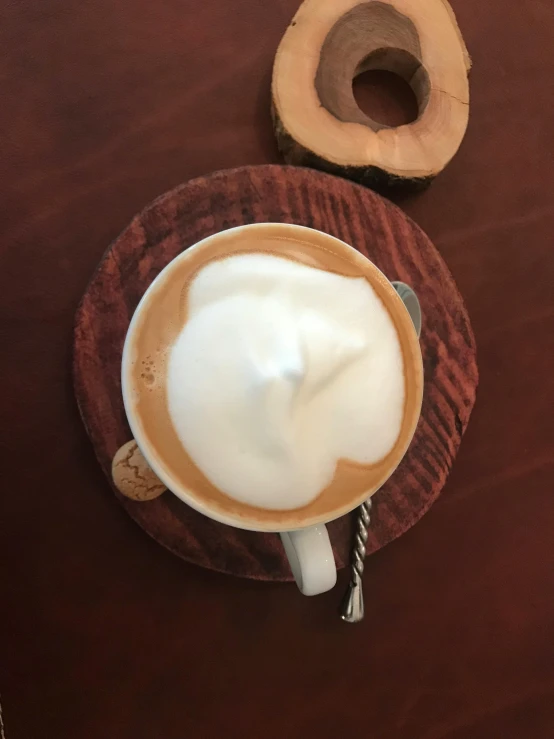 a cup of coffee and a donut on a table, by Robbie Trevino, hurufiyya, whipped cream on top, on wood, thumbnail, shogakukan
