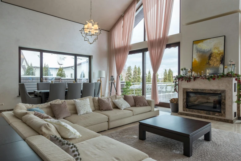 a living room filled with furniture and a fire place, inspired by david rubín, pexels contest winner, beautiful drapes, whistler, high ceiling, pink accents