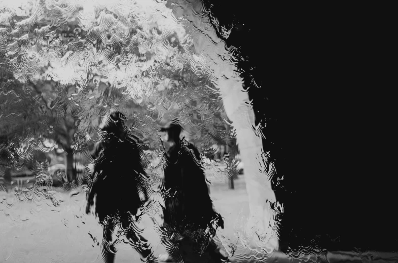 a black and white photo of two people walking in the rain, by Ker-Xavier Roussel, conceptual art, liquid glass, cowboy, saatchi art, two characters