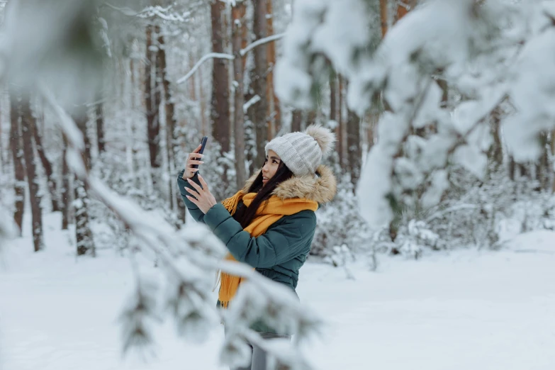 a woman taking a picture of herself in the snow, trending on pexels, avatar image, fan favorite, canvas, espoo