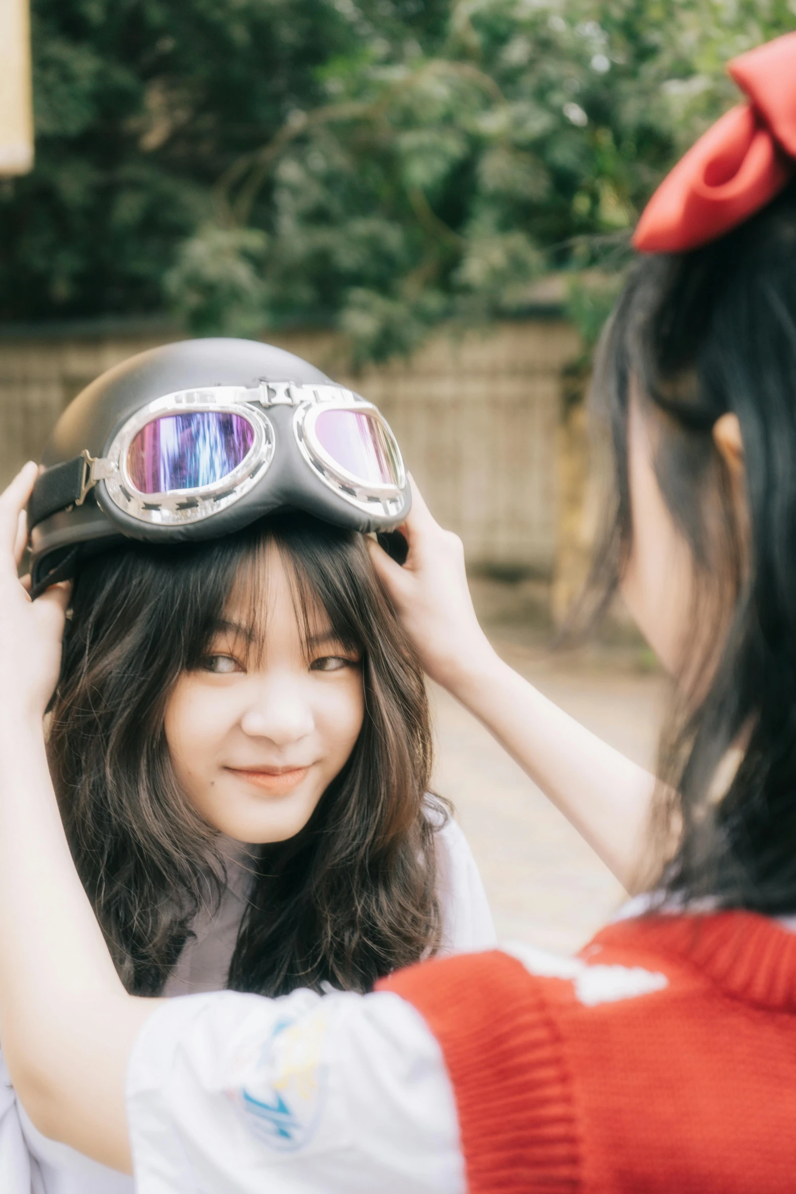 a woman putting a helmet on another woman's head, trending on unsplash, ulzzang, cute pilot girl, avatar image, grainy photo