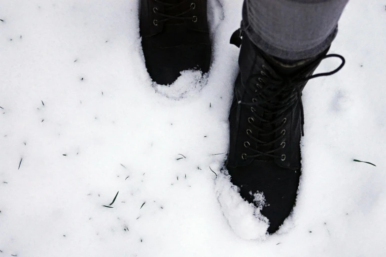 a person standing in the snow wearing black boots, antipodeans, background image, fan favorite, instagram post, military boots