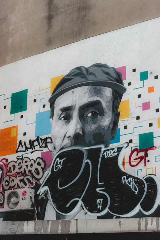 a mural of a man on the side of a building, graffiti art, by artist, pexels contest winner, street art, with the face of nicholas cage, 2 5 6 x 2 5 6 pixels, the last portrait of mac miller, portrait of paris