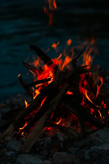 a close up of a fire near a body of water, by Jan Rustem, outdoor photo