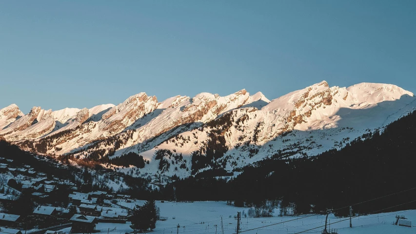 a group of people riding skis down a snow covered slope, pexels contest winner, les nabis, at dusk at golden hour, bakelite rocky mountains, slightly pixelated, snow capped mountains