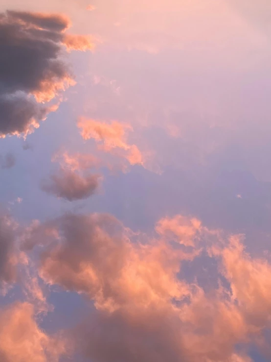 a large jetliner flying through a cloudy sky, a picture, unsplash, romanticism, orange / pink sky, ☁🌪🌙👩🏾, soft lilac skies, a still of an ethereal