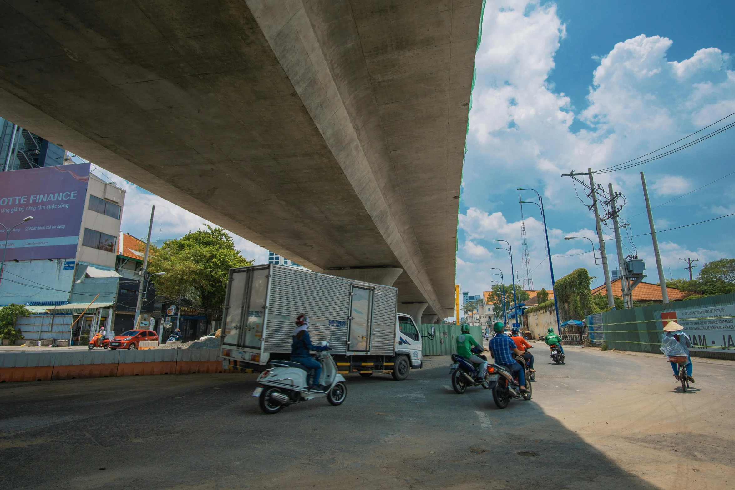 a group of people riding motorcycles under a bridge, by Joze Ciuha, unsplash, realism, sri lanka, monorail station, split near the left, profile image