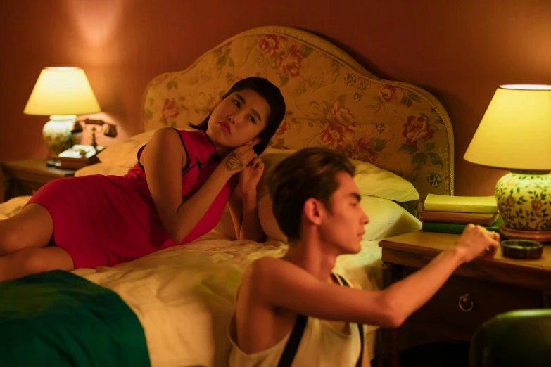 a man and a woman laying on a bed, jin shan and ross tran, looking distracted, felix kelly, chinese woman