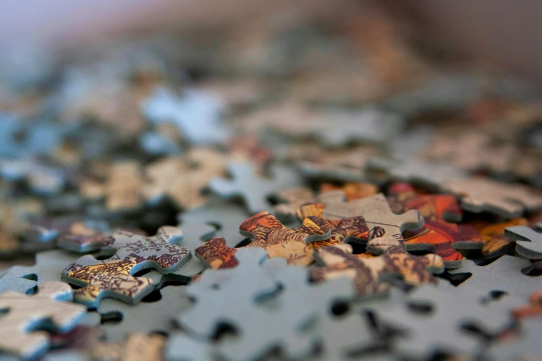 a pile of puzzle pieces sitting on top of a table, a jigsaw puzzle, by Daniel Lieske, pexels, intricate oil details, microscopic view, multiple stories, brown