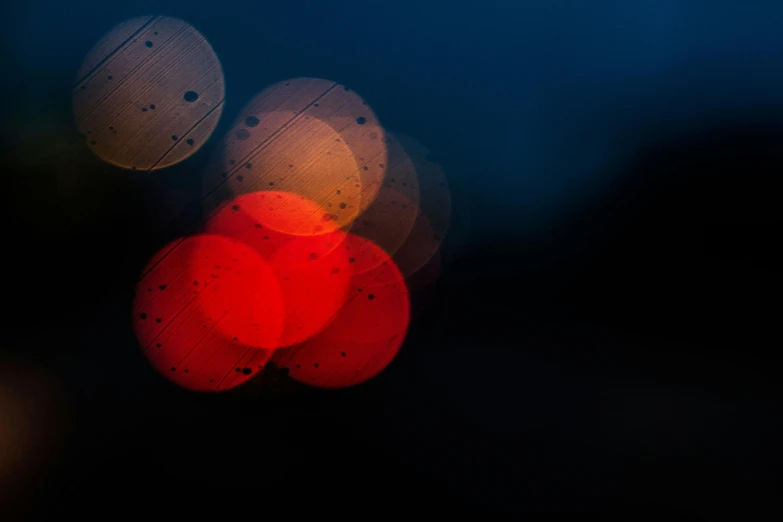 a blurry picture of a street at night, a microscopic photo, by Jan Rustem, unsplash, lyrical abstraction, dark blue and red, circles, overcast bokeh - c 5, soft light - n 9