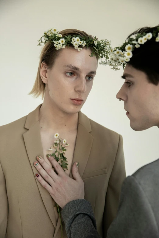 a man standing next to a woman with a flower crown on her head, by Zofia Stryjenska, trending on unsplash, romanticism, non binary model, margiela campaign, two young men, press shot