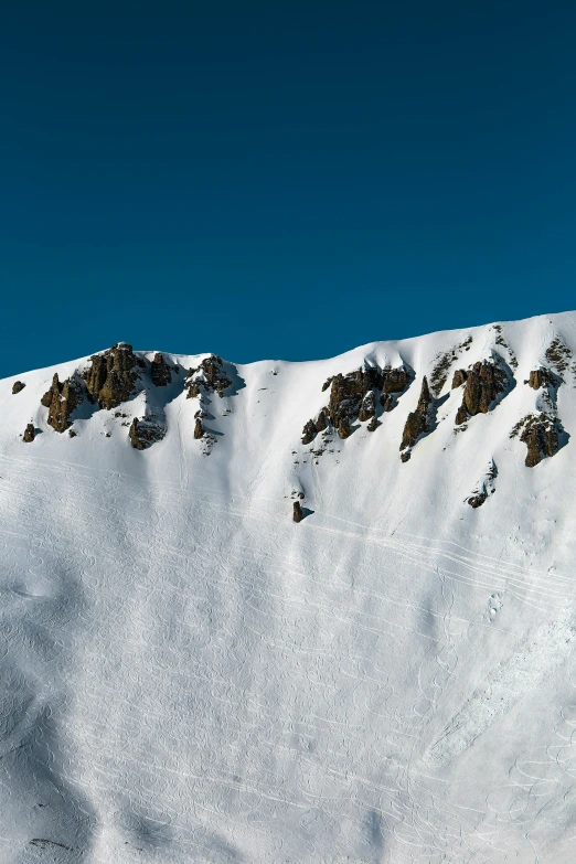 a man riding a snowboard down the side of a snow covered slope, les nabis, viewed from afar, mammoth, rock arcs, ultrawide image