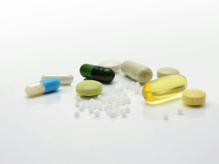 a variety of pills and capsules on a white surface, by Alison Watt, plasticien, 3 4 5 3 1, true realistic image, healthcare, village