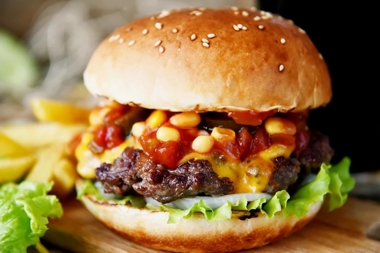 a hamburger sitting on top of a wooden cutting board, by Joe Bowler, overflowing with baked beans, red and yellow scheme, 💋 💄 👠 👗, istock