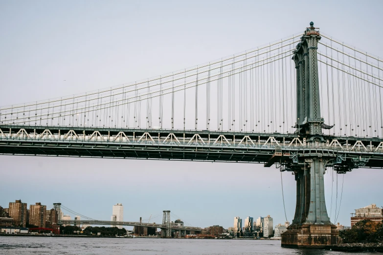 a large bridge over a body of water, inspired by Thomas Struth, unsplash contest winner, brooklyn, ignant, tall structures, portrait of a big
