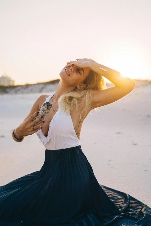 a woman sitting on top of a sandy beach, unsplash, renaissance, doing a sassy pose, sun rising, blonde, emanating magic from her palms