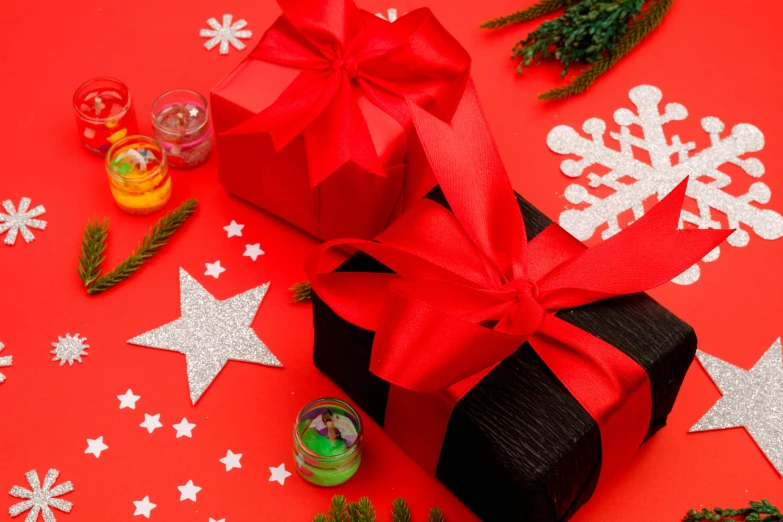 a black gift box sitting on top of a red table, by Julia Pishtar, pexels contest winner, decorated ornaments, bows, a brightly coloured, profile image