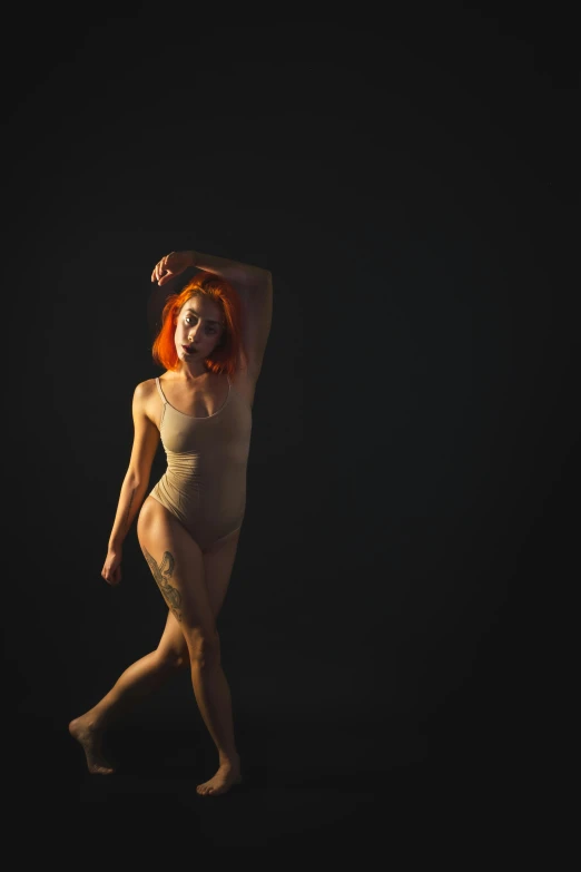 a woman with red hair walking in the dark, a portrait, inspired by Elizabeth Polunin, unsplash, conceptual art, wearing leotard, curved. studio lighting, looking to the side off camera, taken in the early 2020s